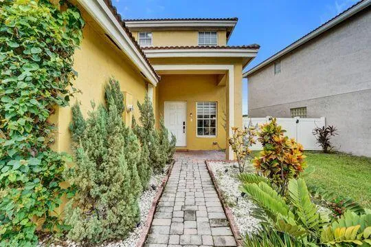 Two-story stucco exterior with a covered​​‌​​​​‌​​‌‌​‌‌​​​‌‌​‌​‌​‌​​​‌​​ entry