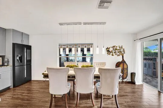 Open-concept dining area featuring wood-finish flooring