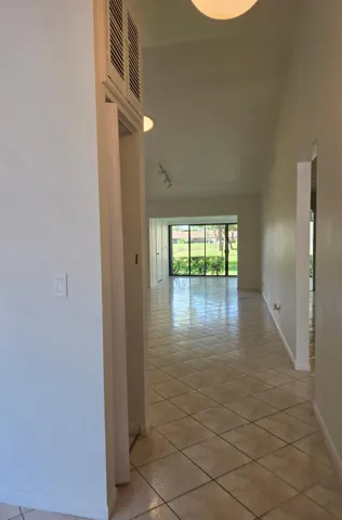 Tile flooring throughout, recessed ceiling lighting, and sliding glass doors
