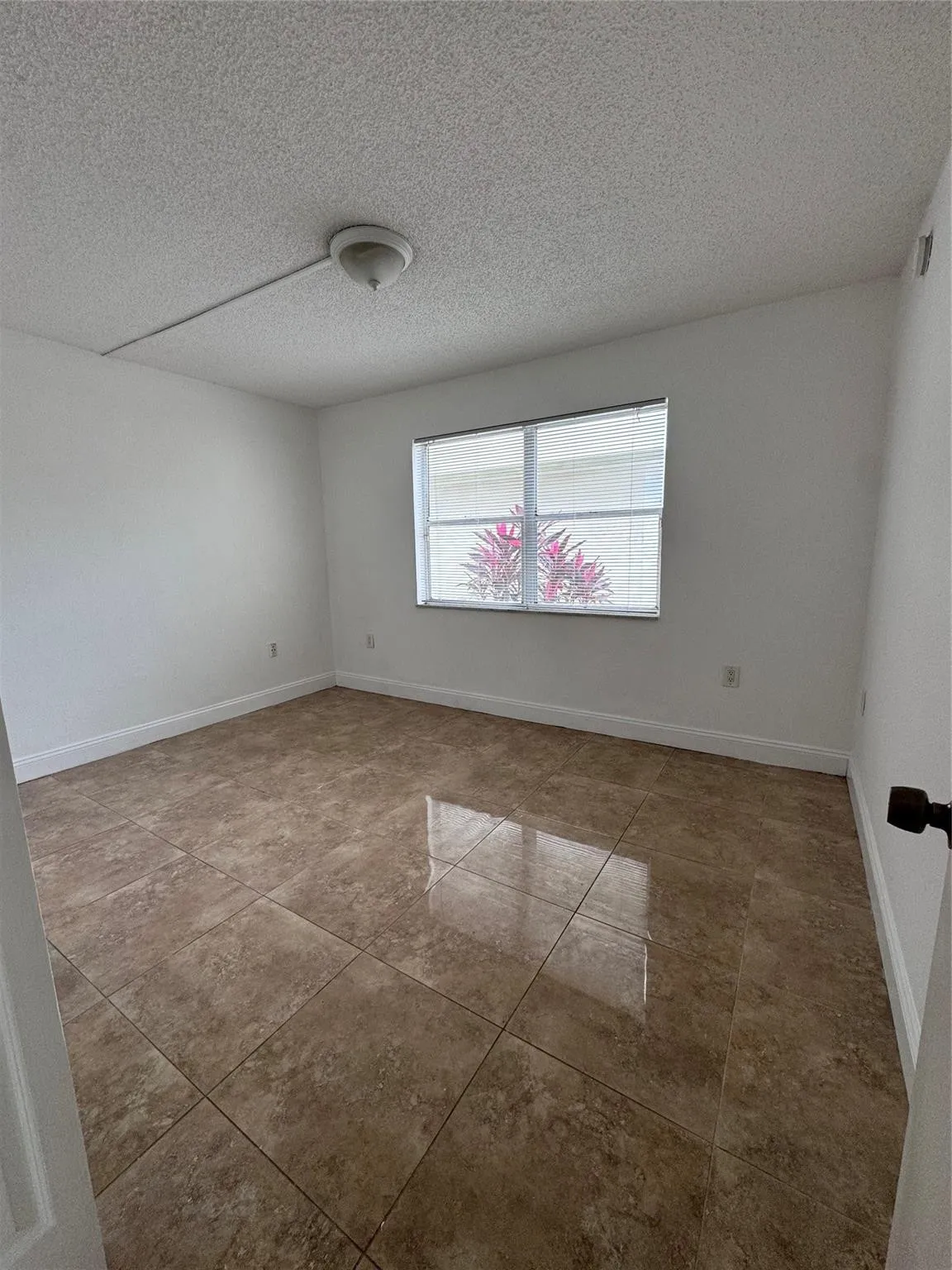 Brown large-format tile flooring with a semi-gloss finish