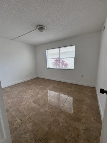 Brown large-format tile flooring with a semi-gloss finish