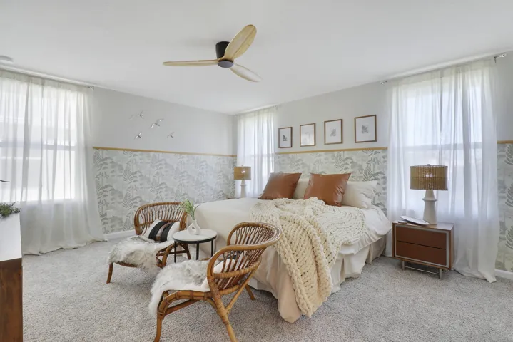 Wallpapered bedroom with fan