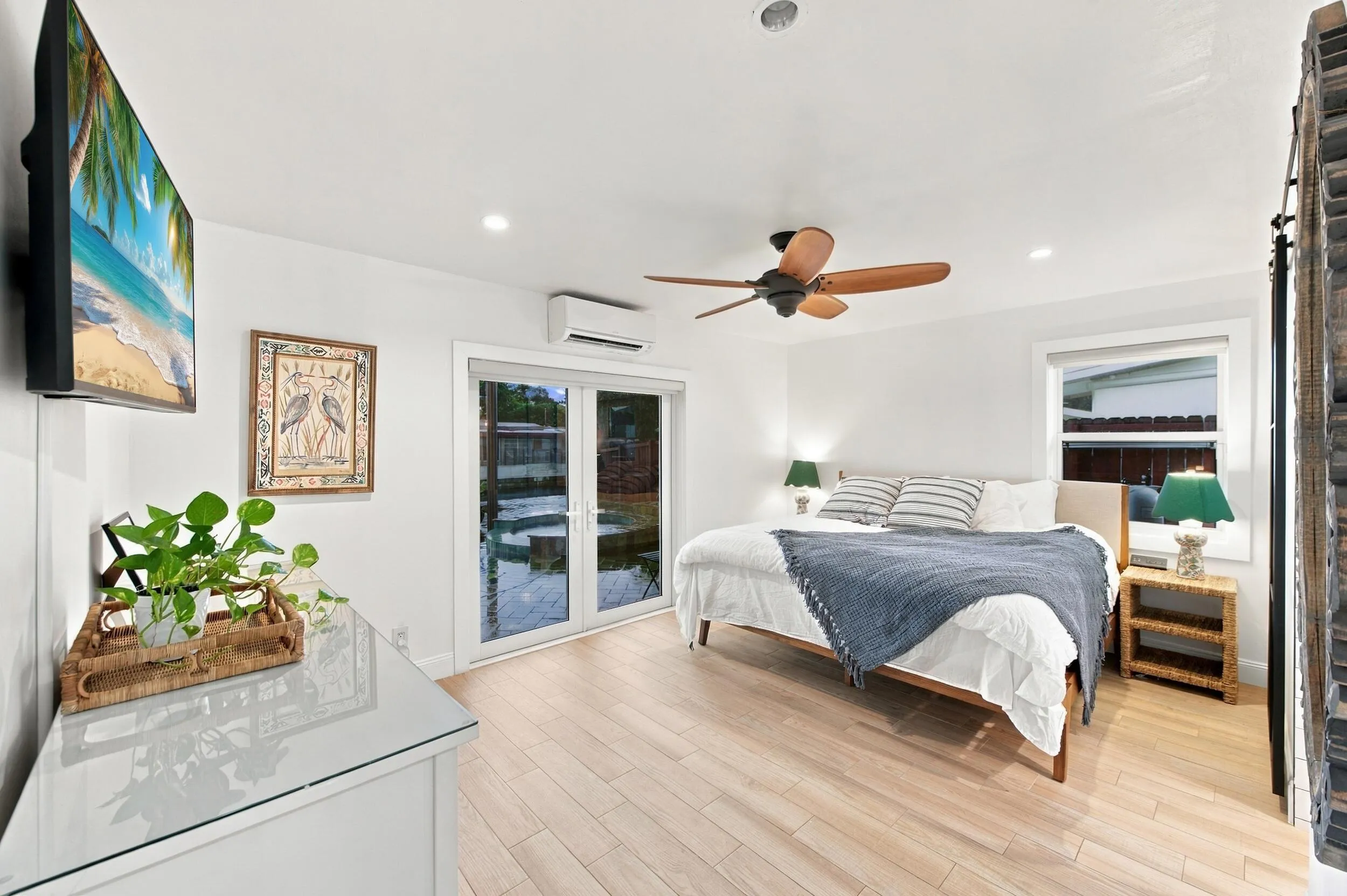 Light wood-finish flooring, ceiling fan with wood blades, recessed lighting, and white walls