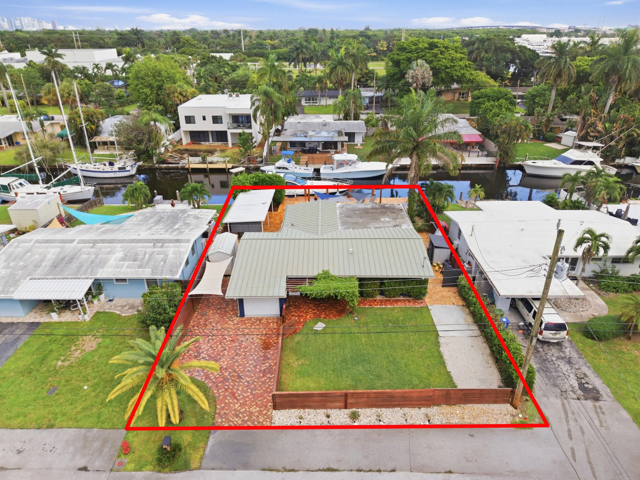 Aerial perspective highlighting the property's waterfront location, private boat dock, and surrounding canal