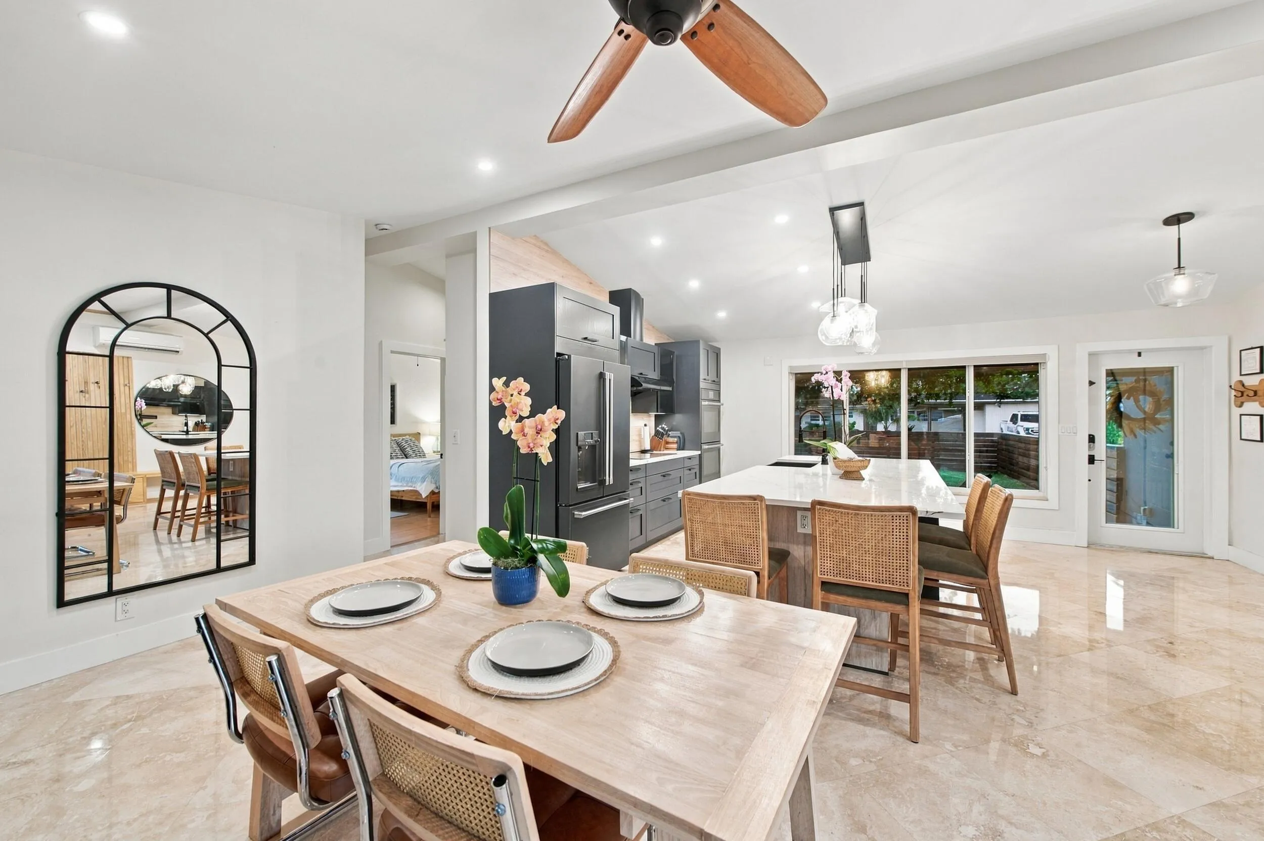 Open-concept interior featuring recessed lighting, a modern ceiling fan, and light-toned flooring