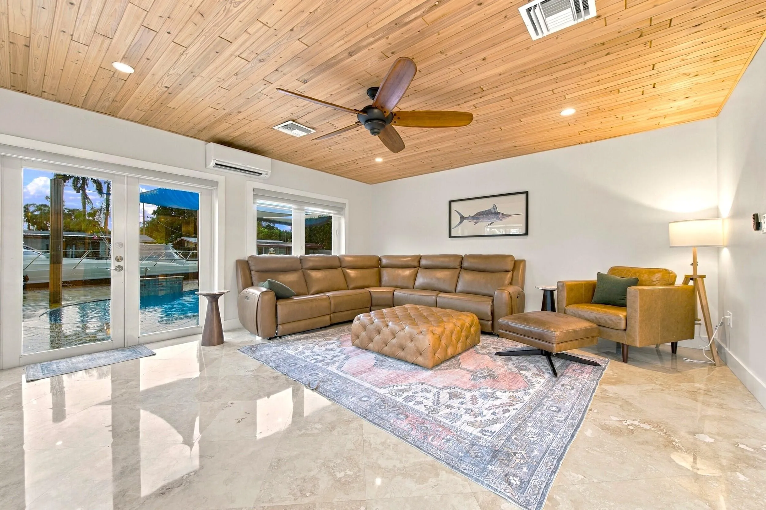Wood-paneled ceiling with recessed lighting and a ceiling fan