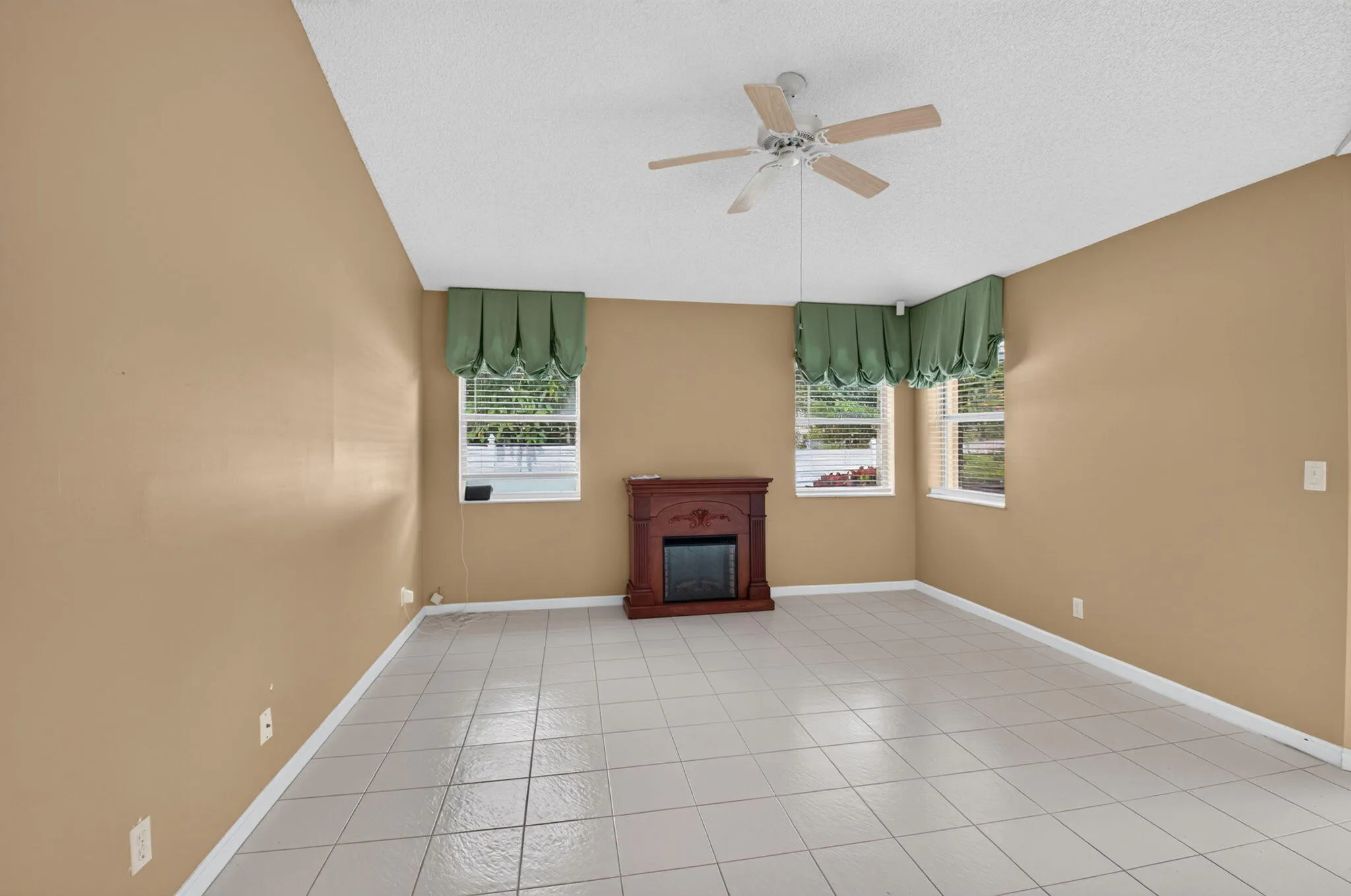 Tile flooring throughout with a ceiling fan light fixture