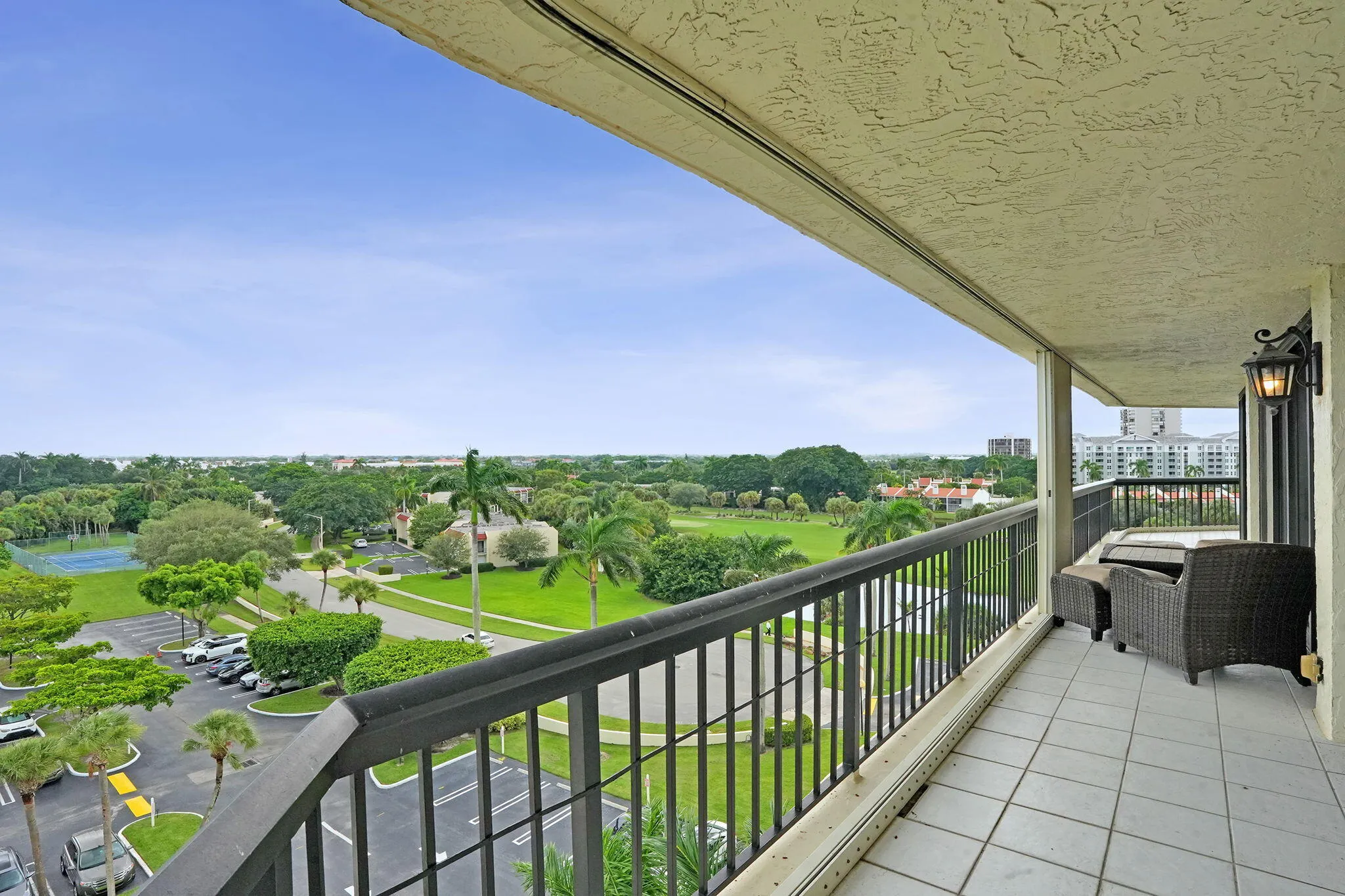 Wraparound balcony overlooking landscaped grounds and golf course