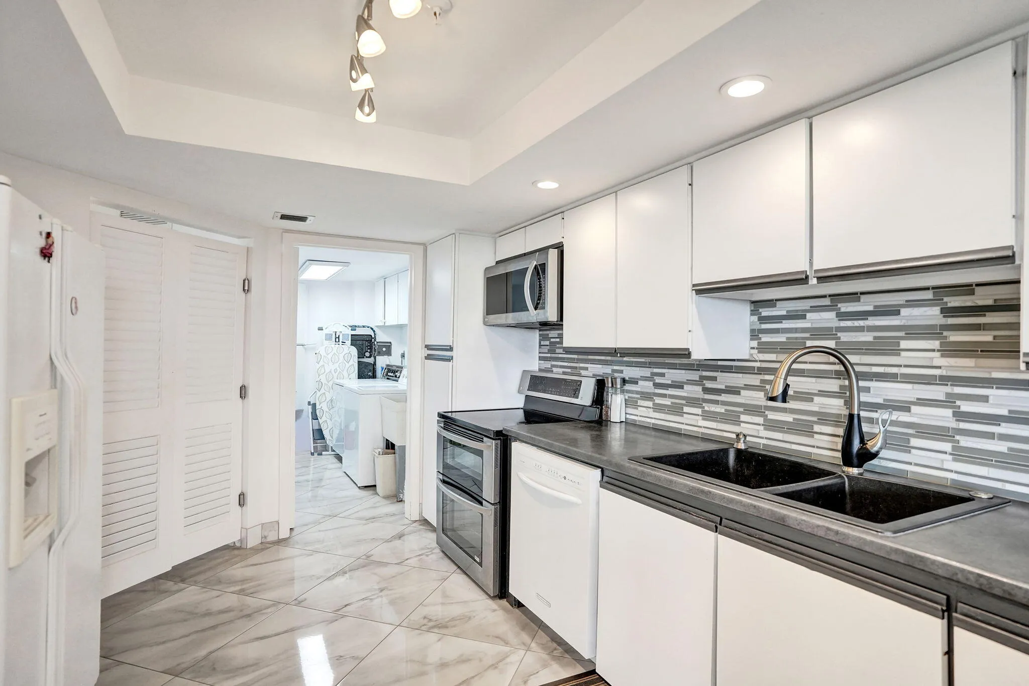 Galley kitchen with abundant cabinetry