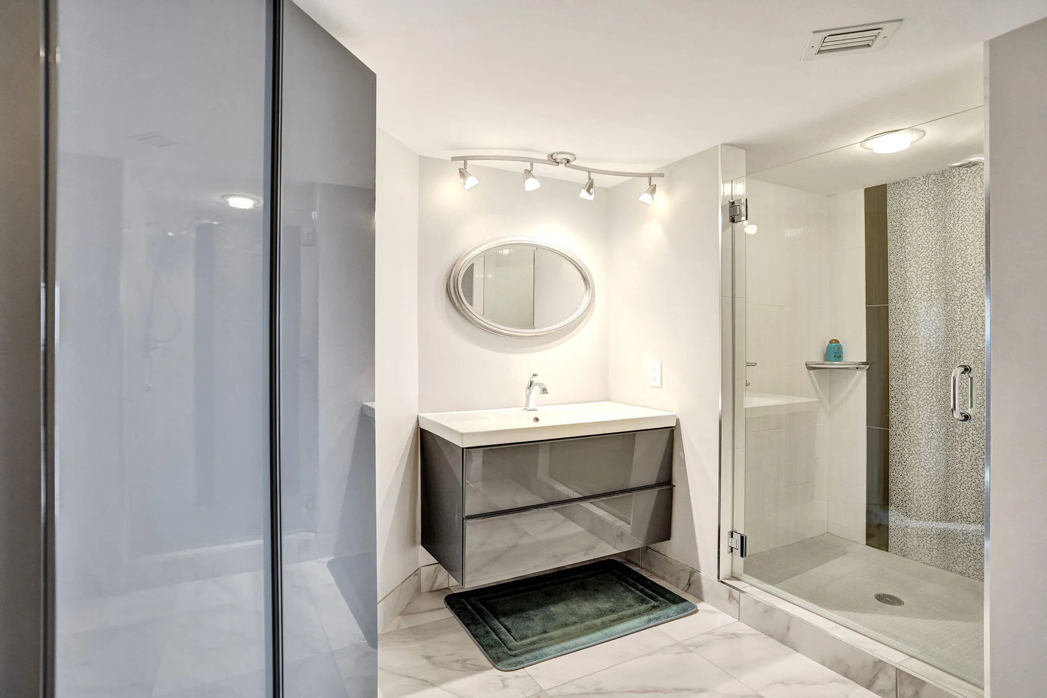 Primary bath with glass-enclosed shower