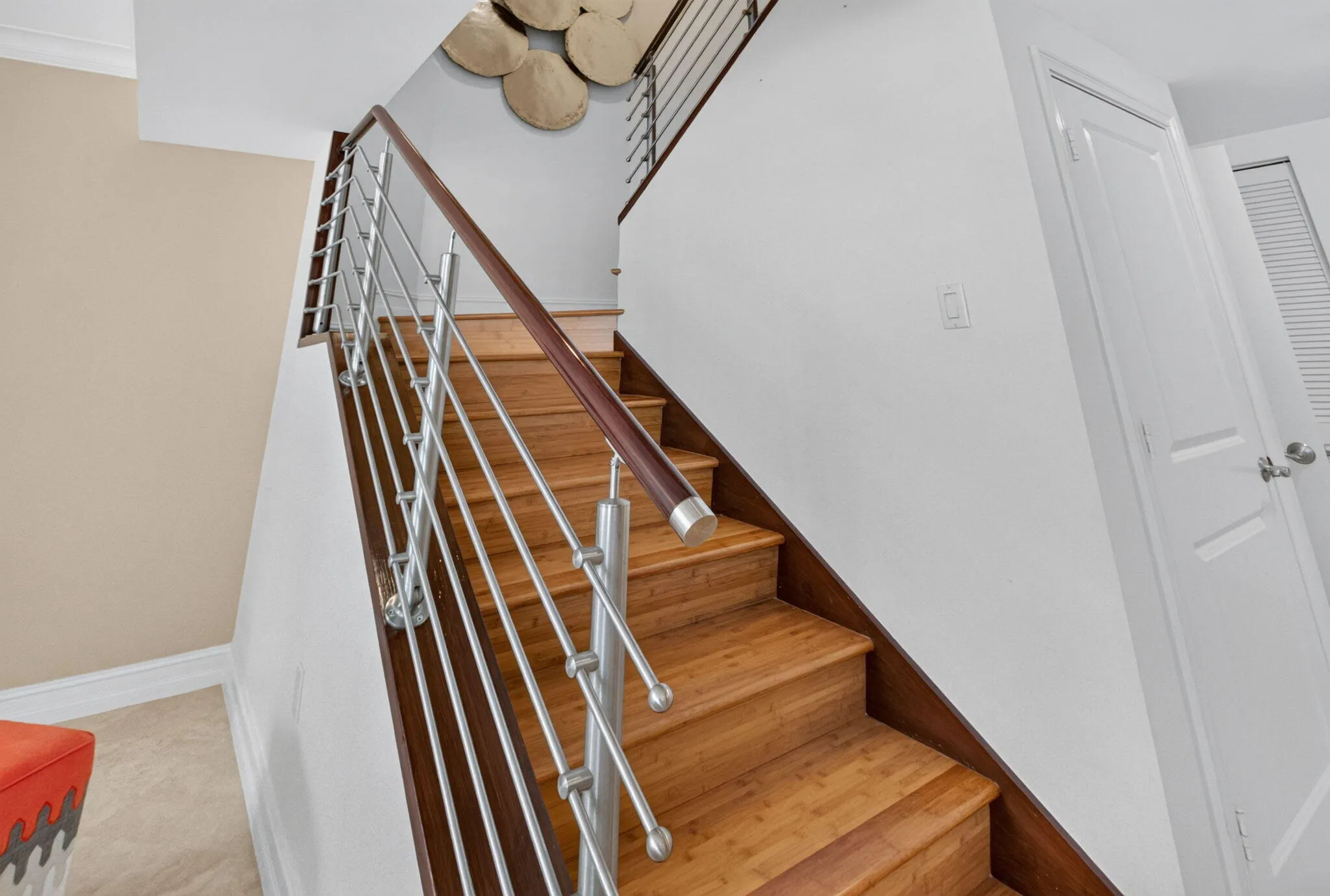 Wood-finish stairs with a stainless steel and wood railing