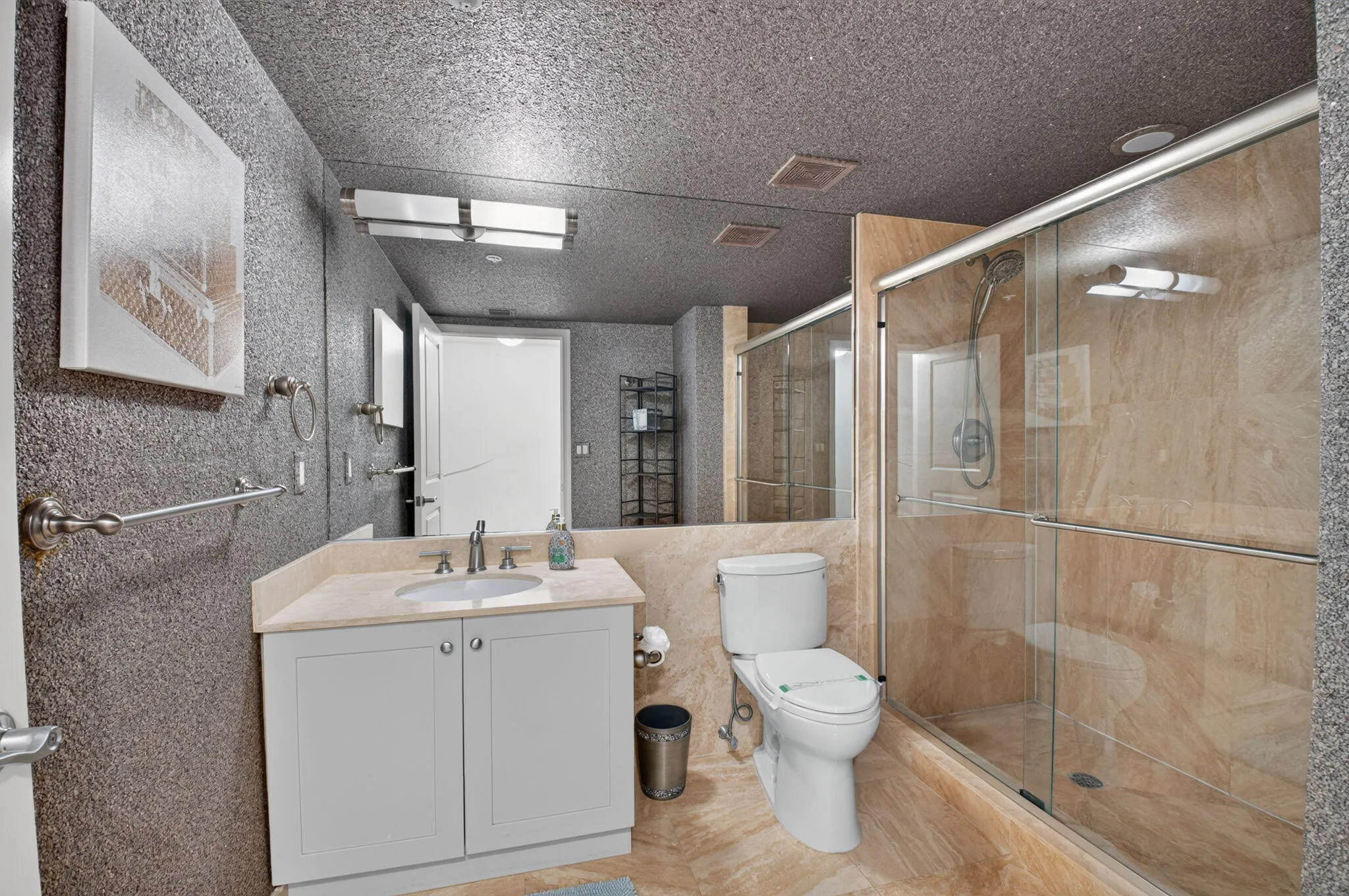 Spacious common area featuring recessed lighting, tray ceiling, and full-height windows with wood-frame accents