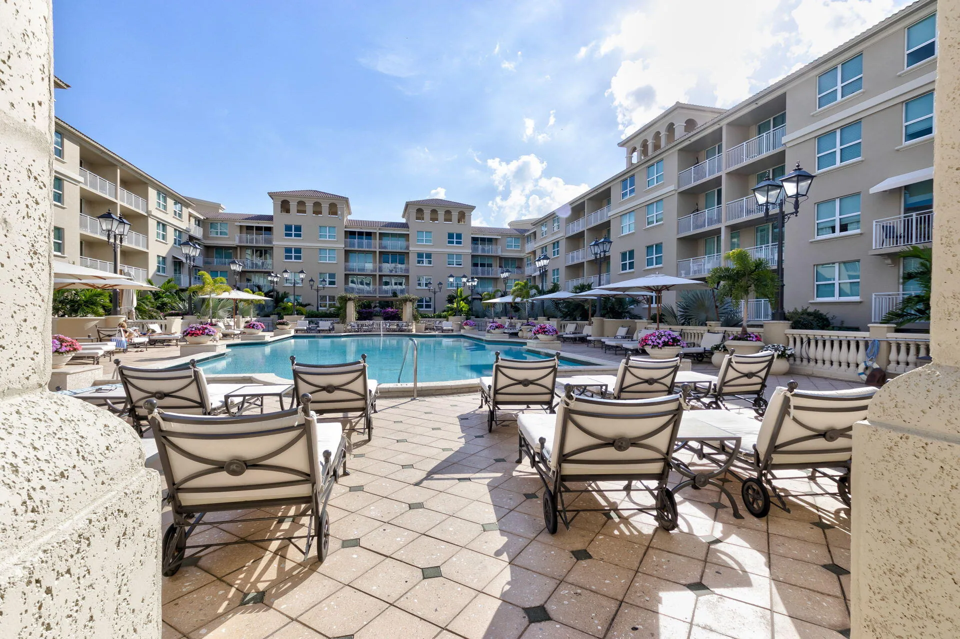 Resort-style pool with a surrounding paver patio and ample seating