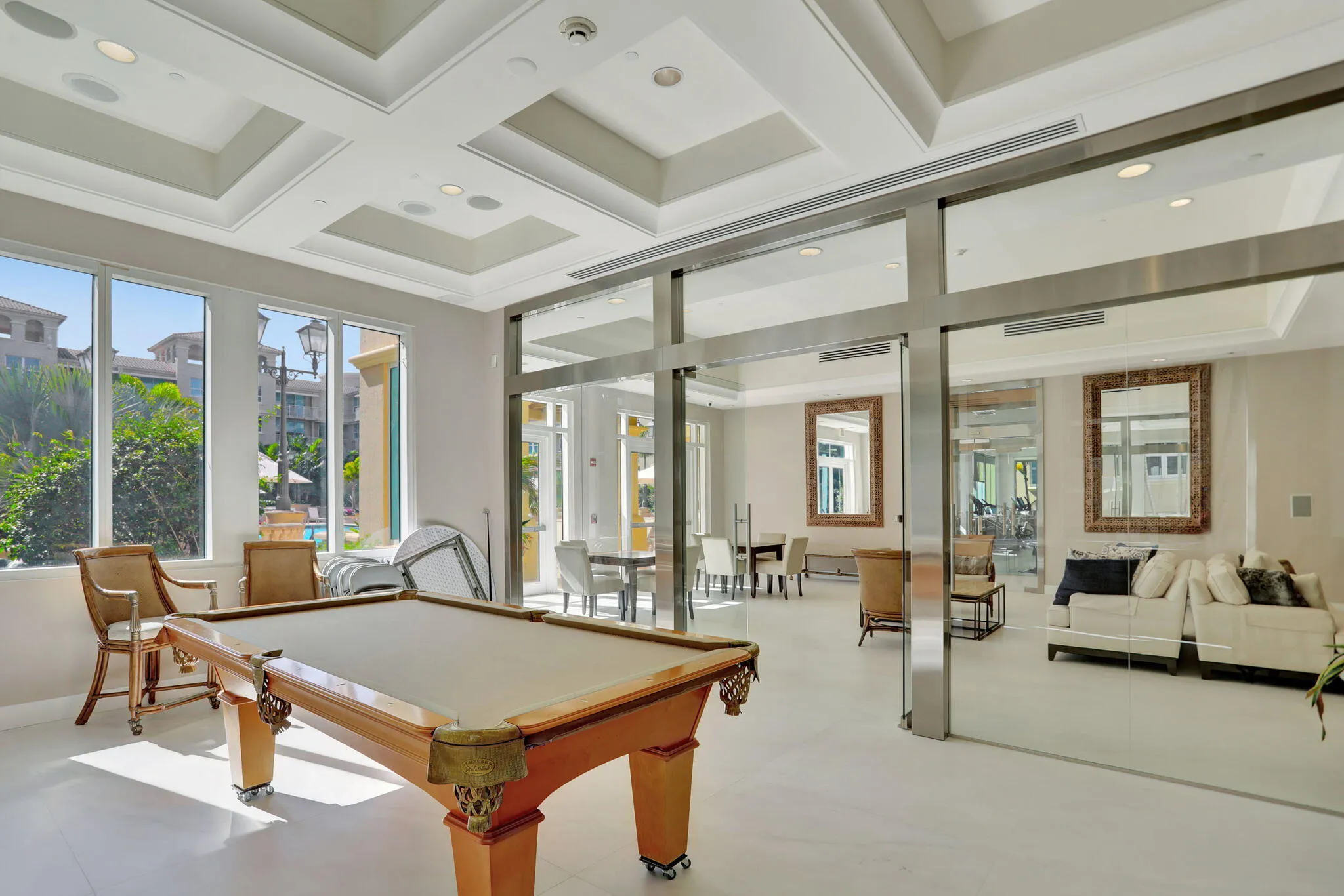 Coffered ceiling with recessed lighting, large pane windows, and polished flooring