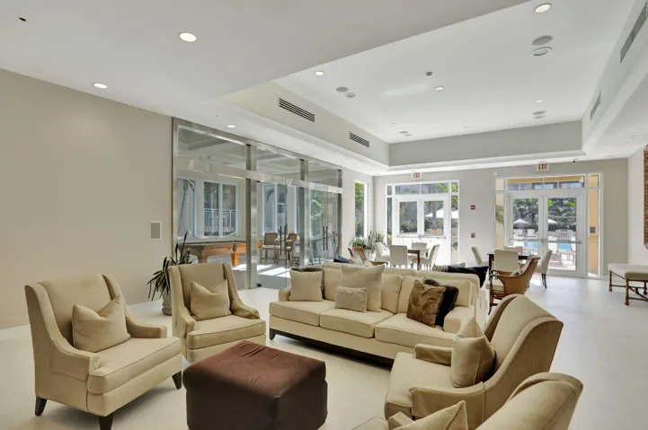Expansive swimming pool with integrated spa and surrounding paver patio