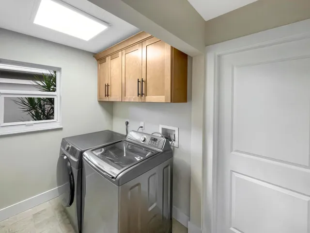 Laundry room between the kitchen and garage