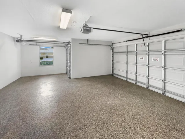 Epoxied garage floor with brand new impact rated garage doors