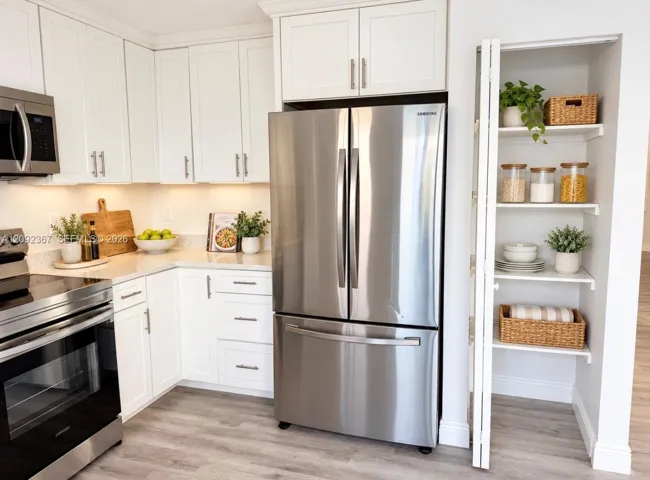 VIRTUAL STAGED - Kitchen and Pantry.