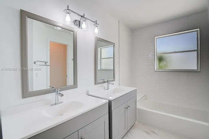Primary Bathroom with double vanities and shower/tub combination.