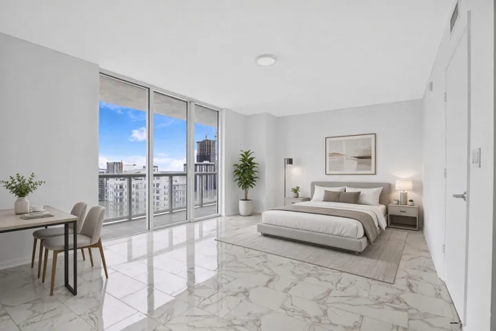 Virtually Staged. White interior walls, marble-finish flooring, recessed ceiling lighting, a contemporary pendant light fixture, and a large sliding glass door.