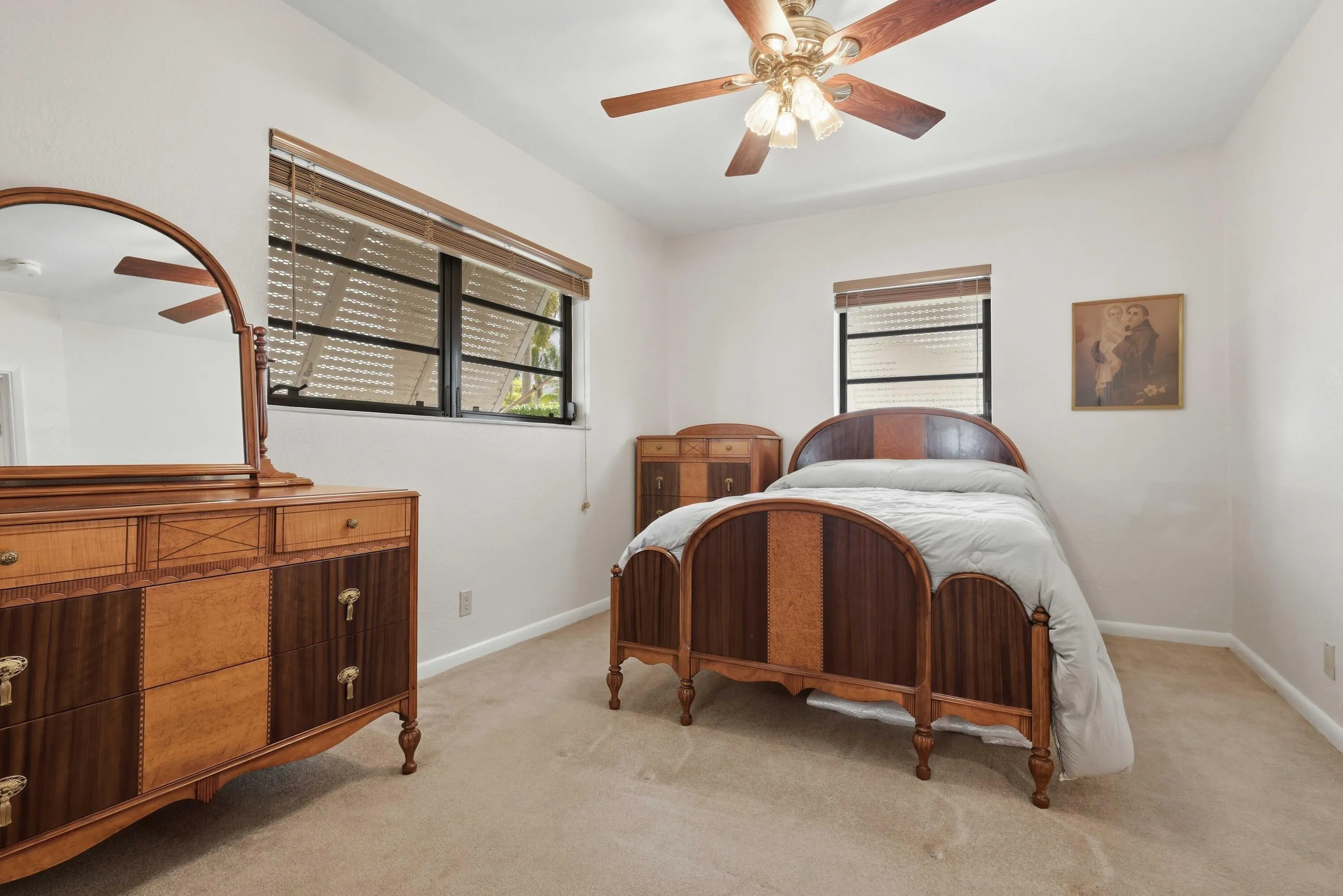 Neutral wall paint with carpeted flooring and ceiling fan