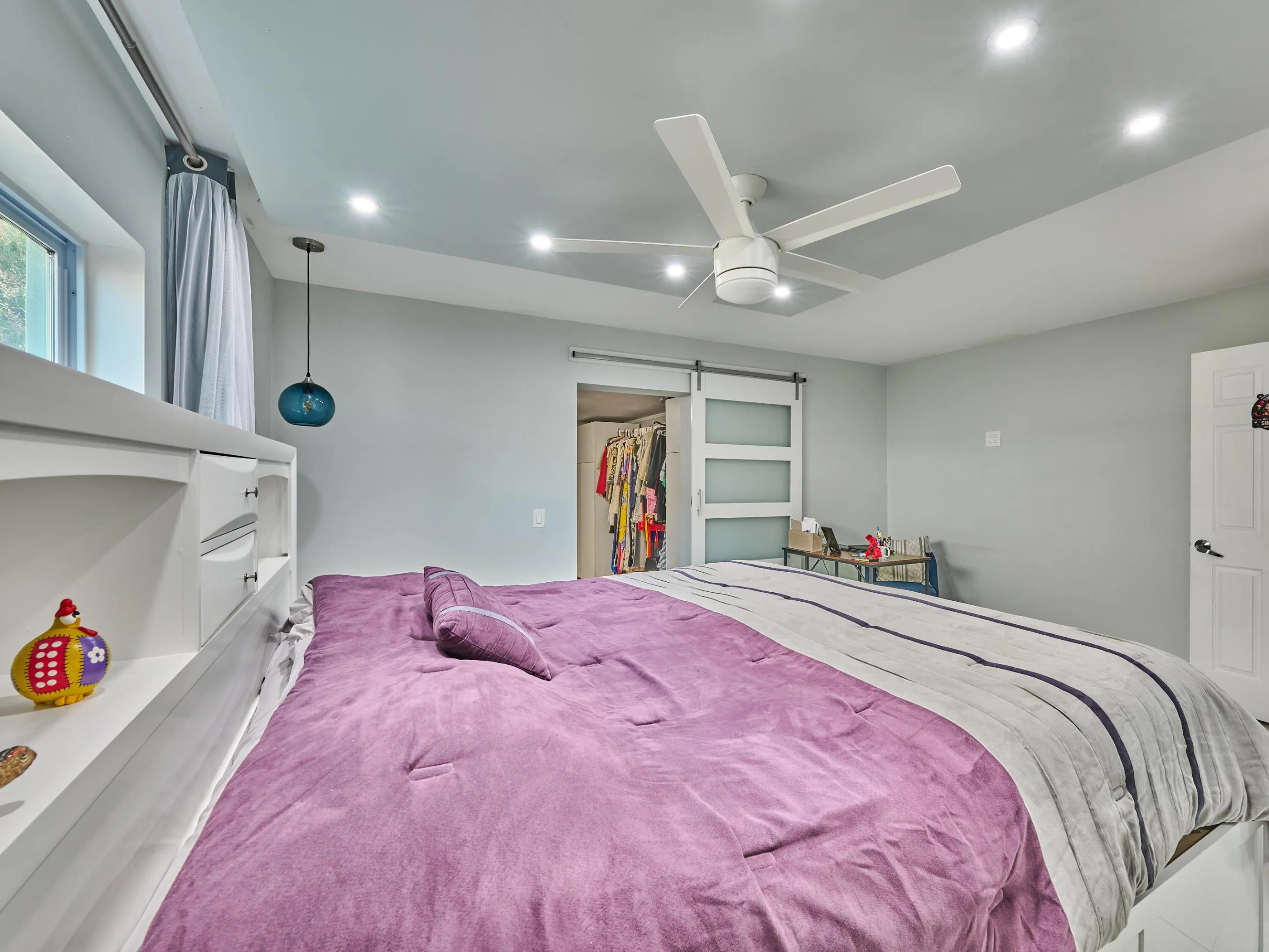 Recessed lighting and a ceiling fan illuminate this space