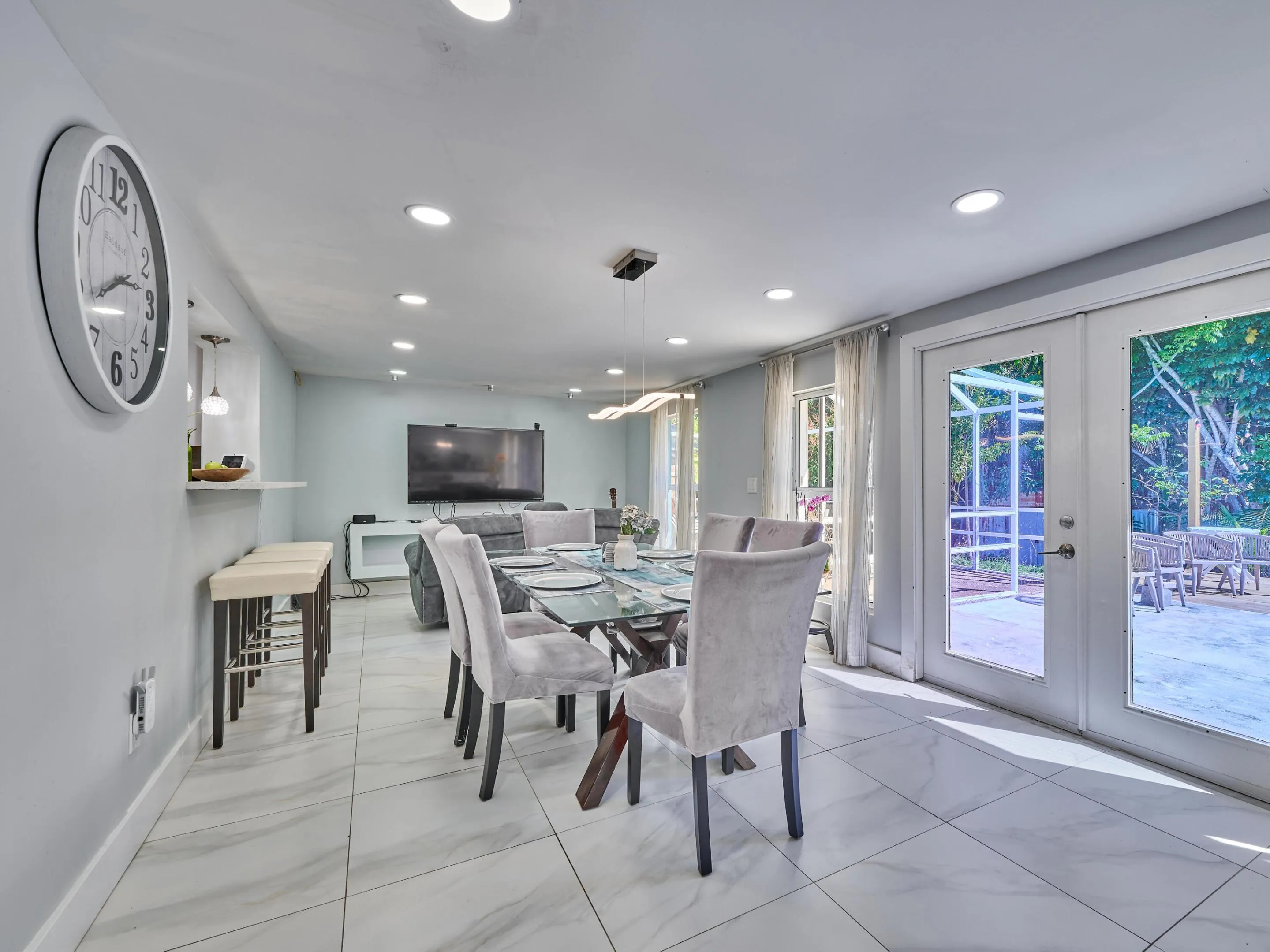 Recessed lighting throughout, tile flooring, and french doors opening to an exterior patio