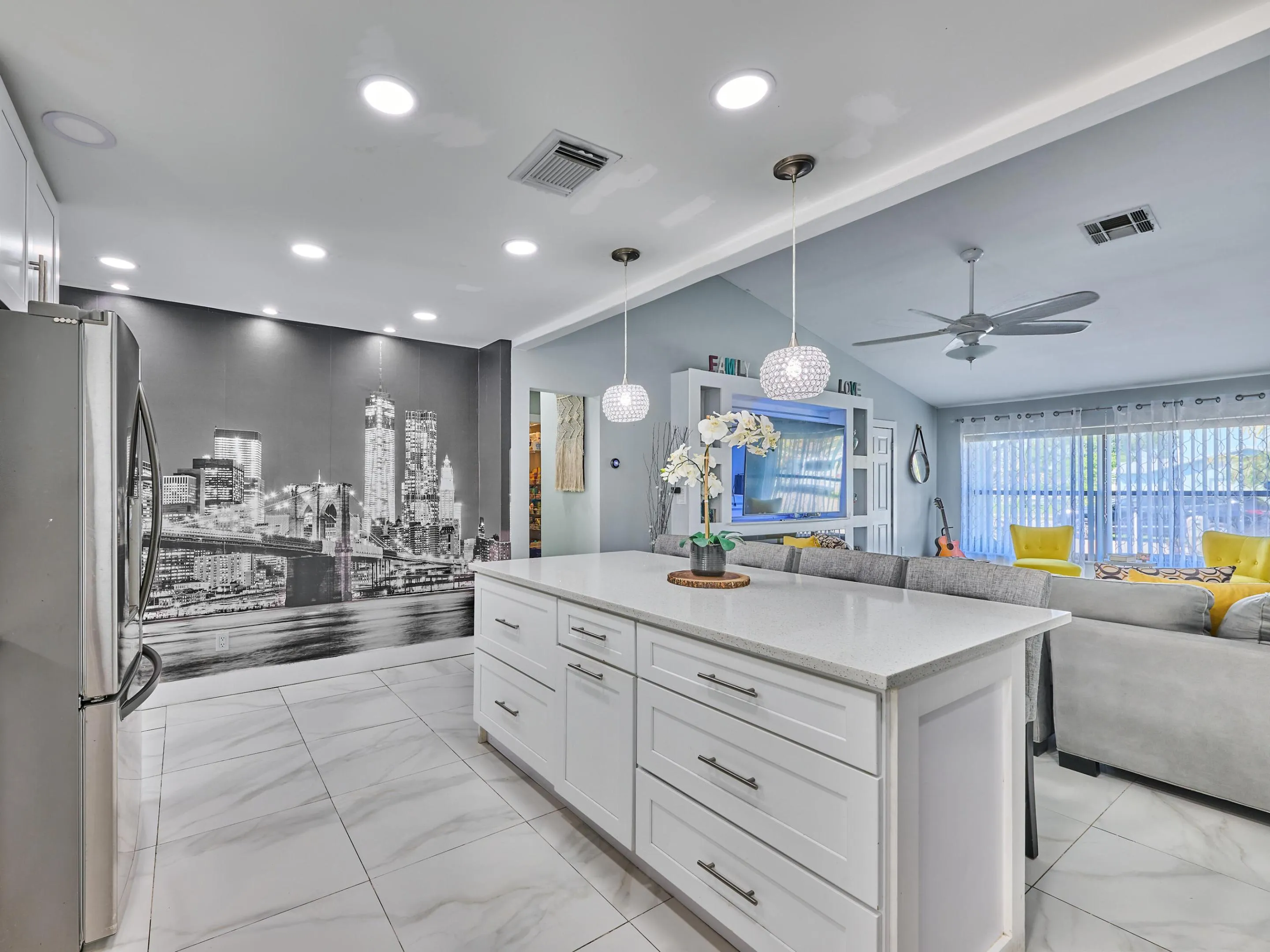Kitchen island with white cabinetry and a light-toned countertop