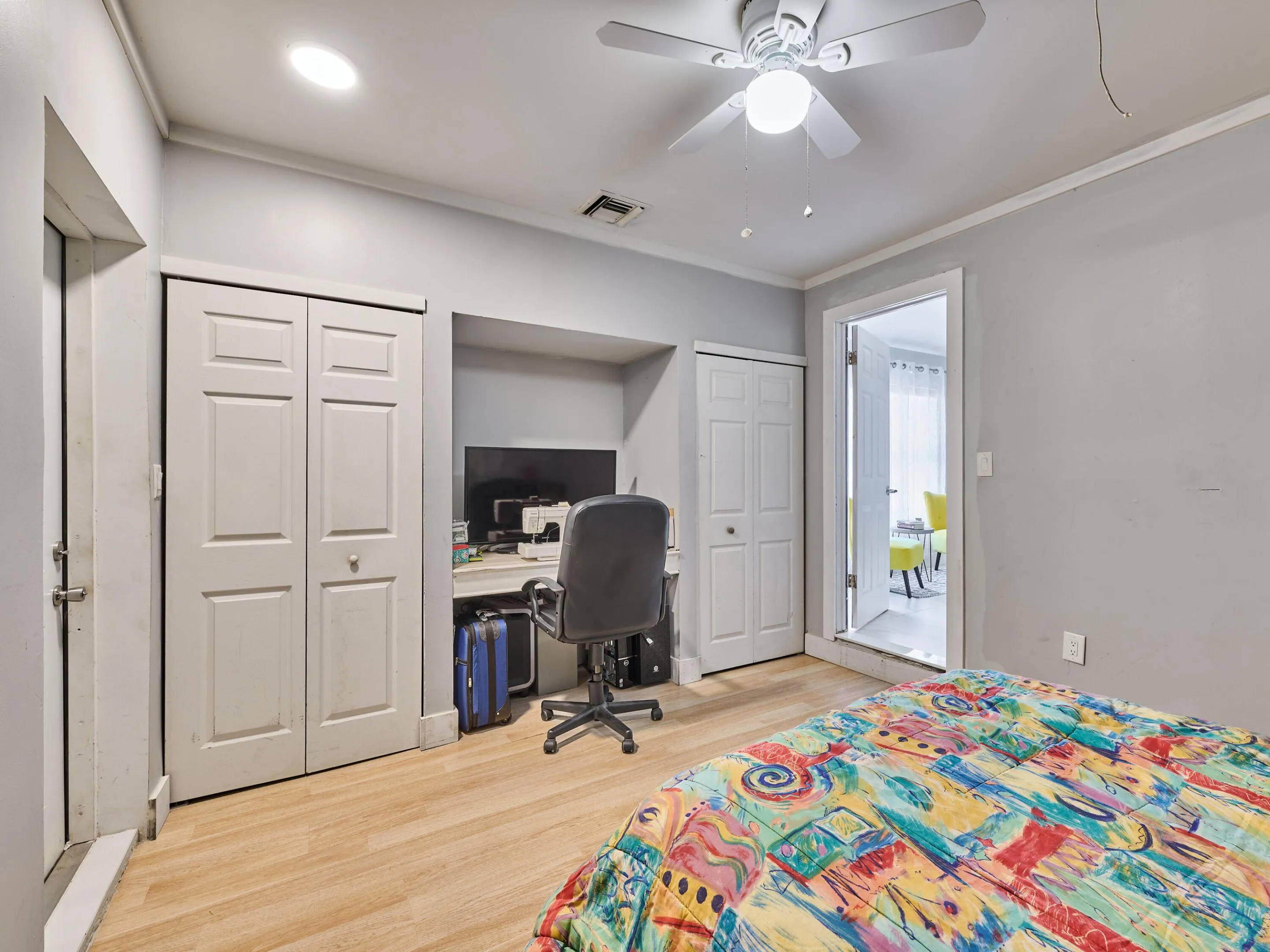 Wood-finish flooring throughout, recessed lighting, and a ceiling fan