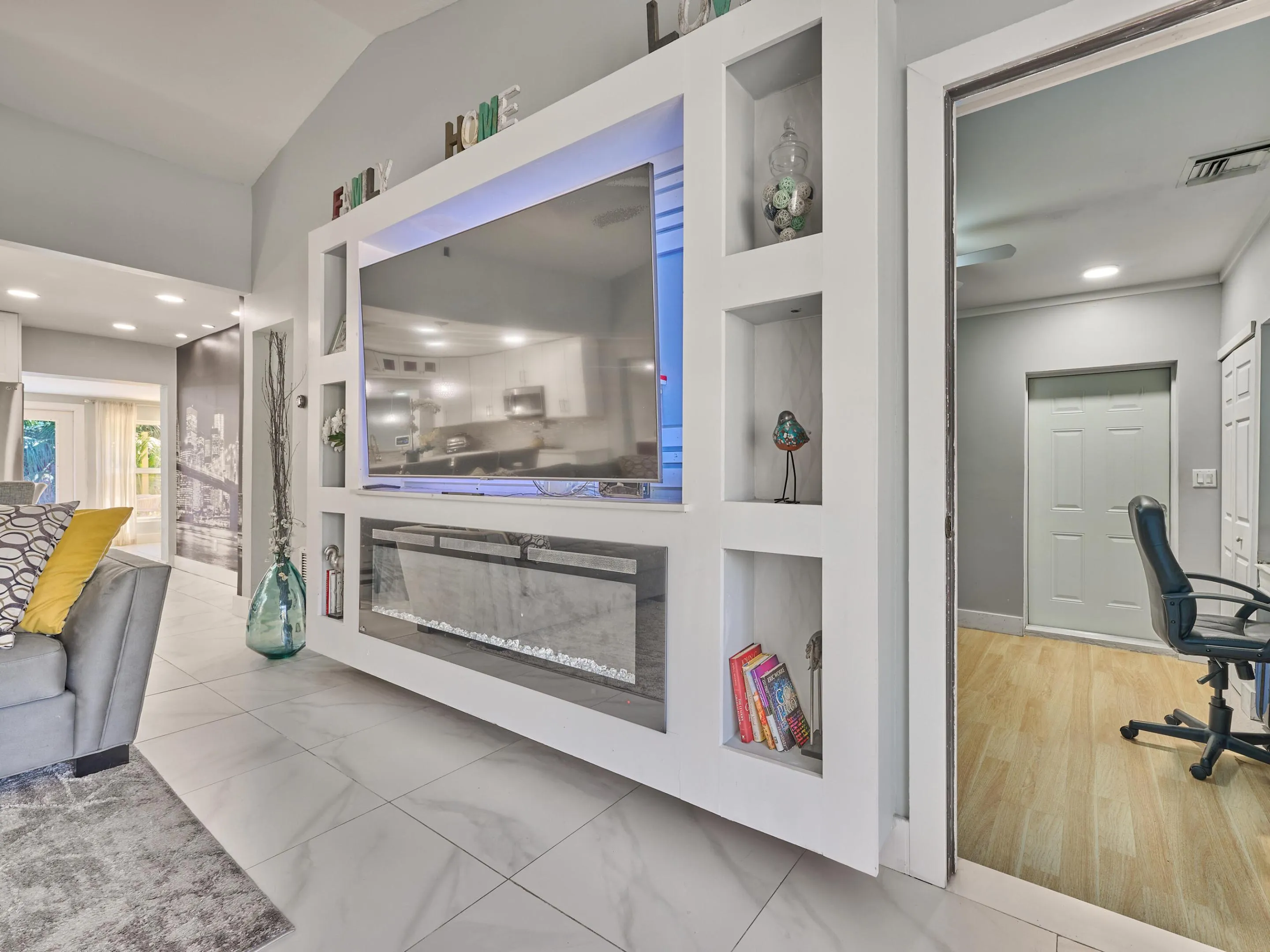 Built-in entertainment wall with integrated shelving and an electric fireplace