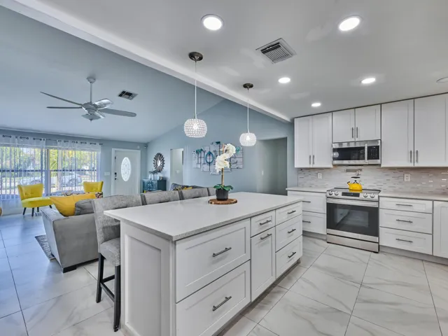 Kitchen island with white cabinetry and quartz countertop