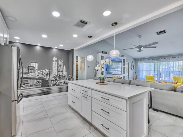 Kitchen island with white cabinetry and a light-toned countertop