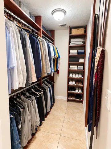 Master Bedroom Closet with closet organizer.