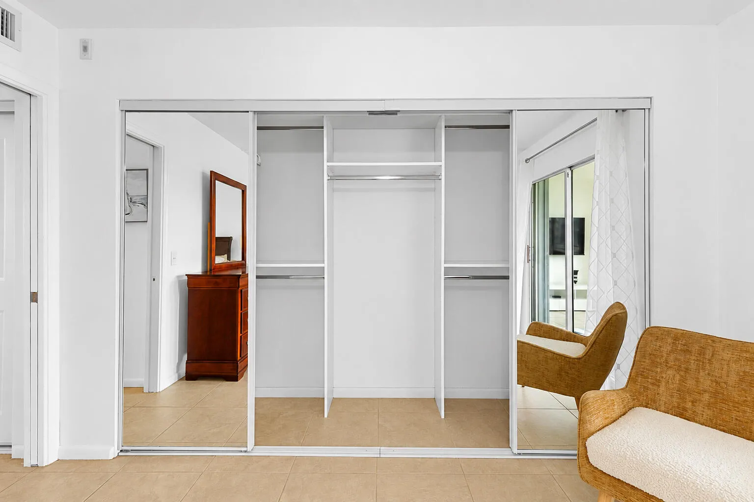 Bedroom closet with custom mirror doors