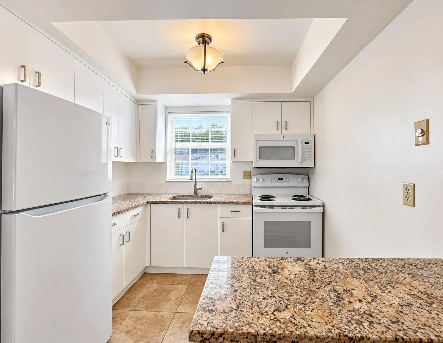 Bright & Pretty UPDATED KItchen Features White Cabinets, Granite Counters, Crisp White Appliances, and Window for Natural Light!