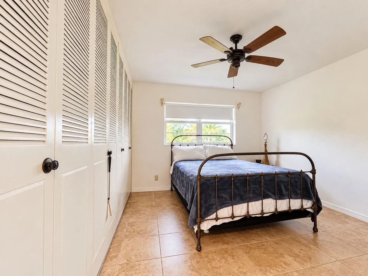 Spacious Bedroom With Tile Flooring and Wall of Closets for Plenty of Storage!