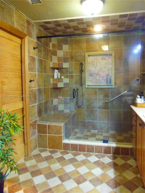 Walk-in shower with a built-in bench and glass enclosure