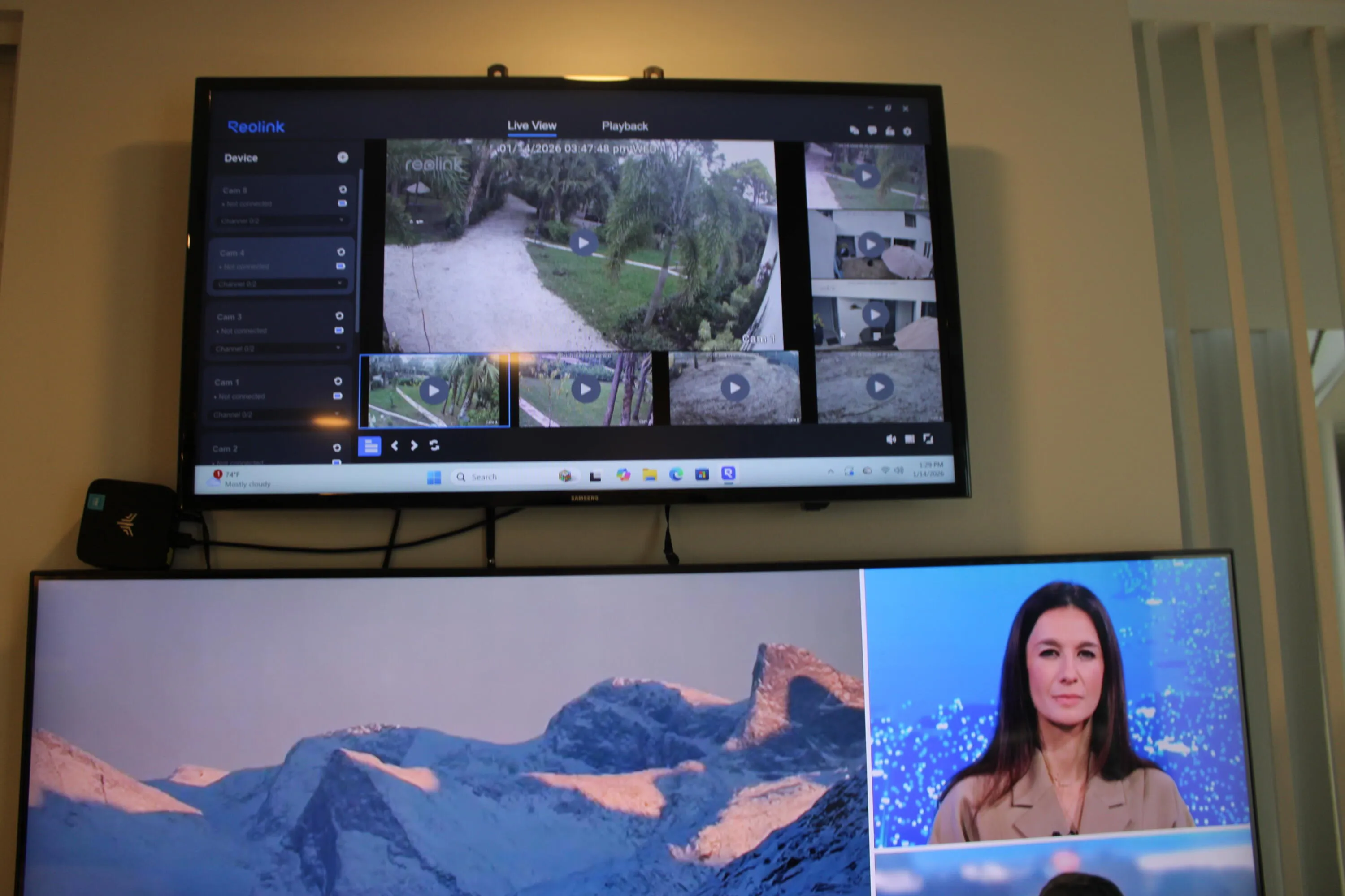 8 camera security camera / lighting system displayed on a dedicated screen above the kitchen TV