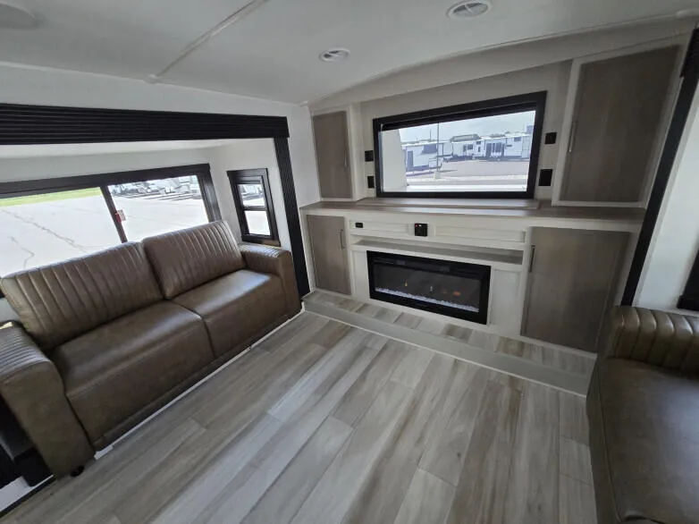 RV: Lounge area with pop-up 52 inch TV and electronic fireplace underneath fireplace. 2 fold down sofa beds.