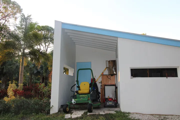 Carport with Johne Deere mower, (Included). Plus fully equipped lockable workshop