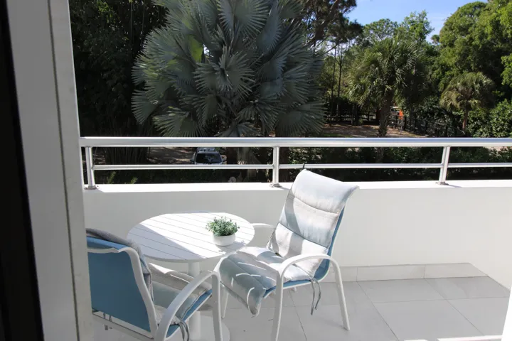 Royal Suite West balcony dining overlooking the second gate and a paddock fenced area