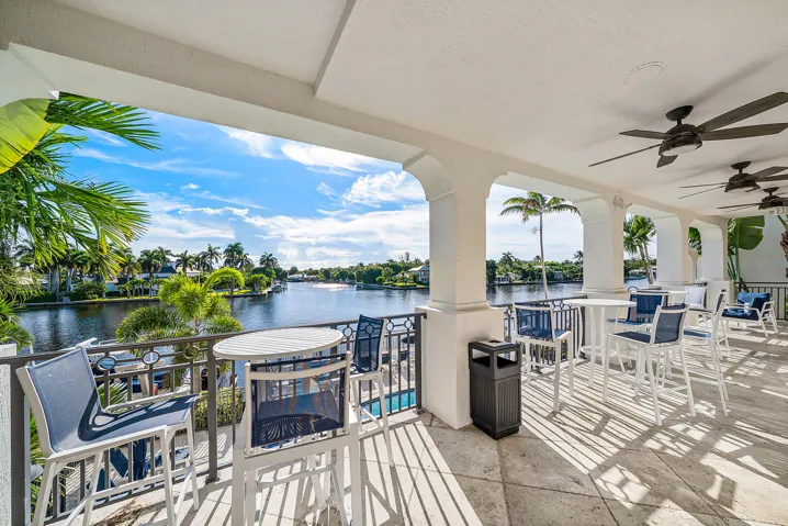 Expansive covered patio featuring arched columns, ceiling fans, directly on the Intracoastal Waterway