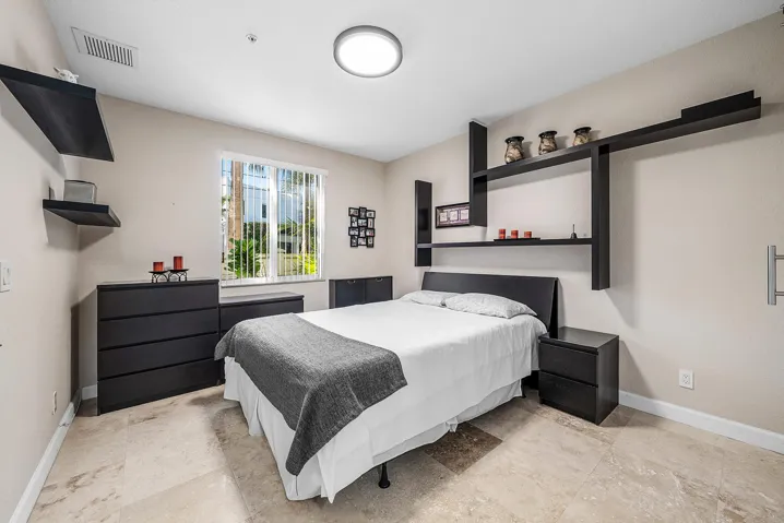 En-suite bedroom with full bath and walk-in closet with barn door
