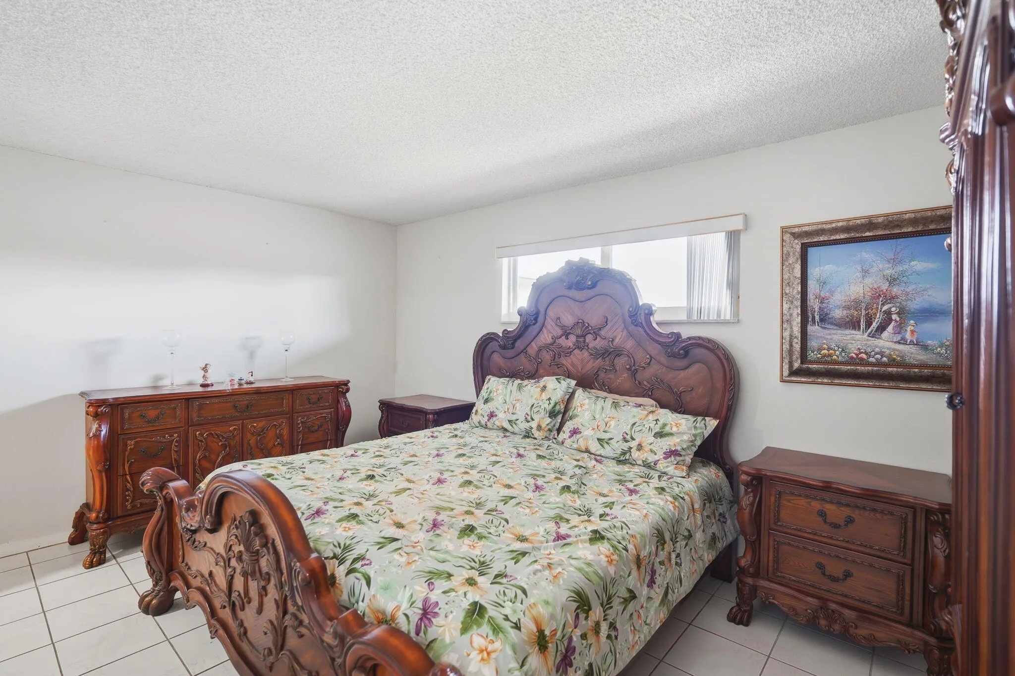 Primary bedroom with beautiful, sturdy solid carved wood furniture
