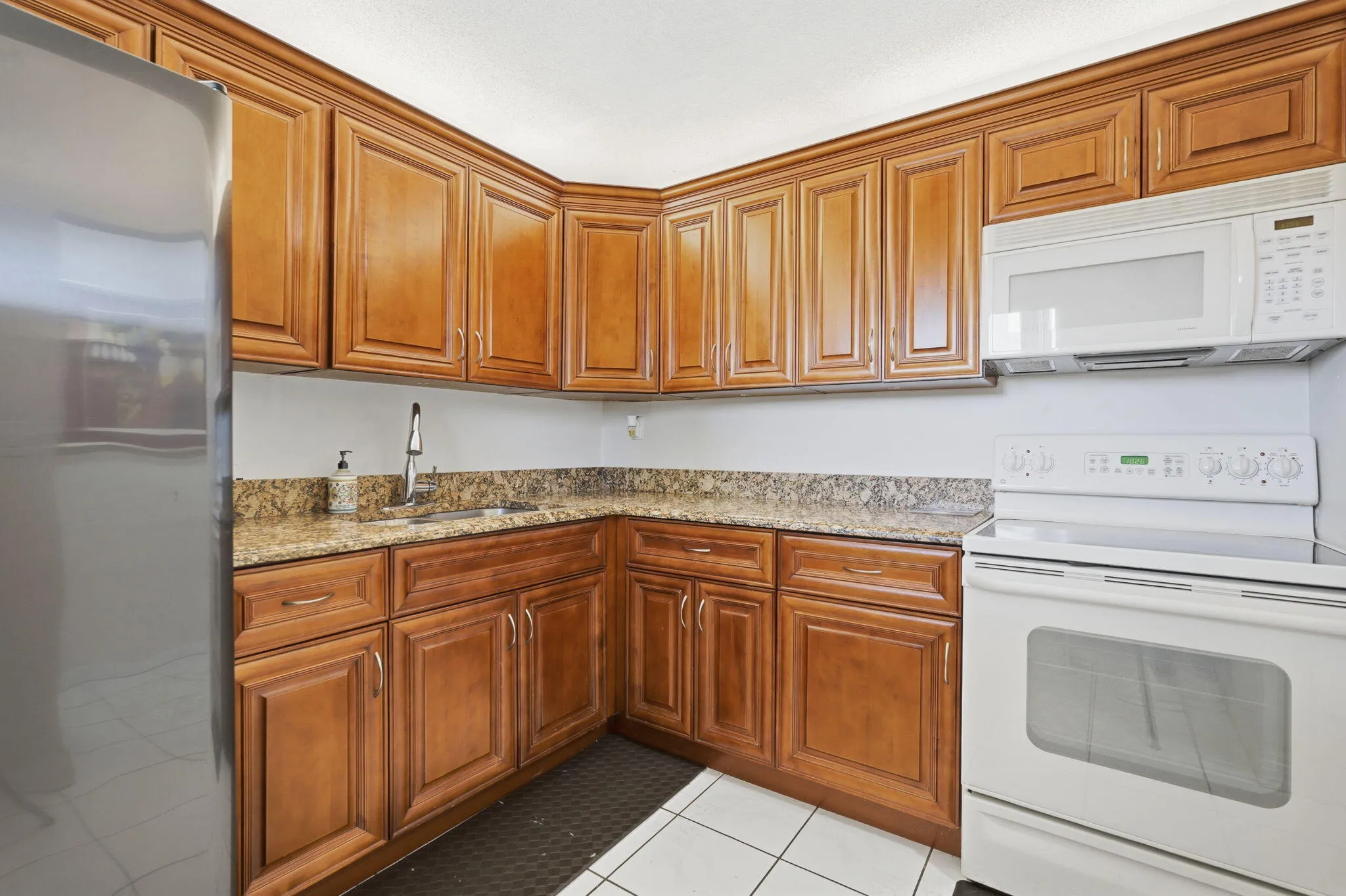 Spacious kitchen with granite countertops and lots of storage in cabinets