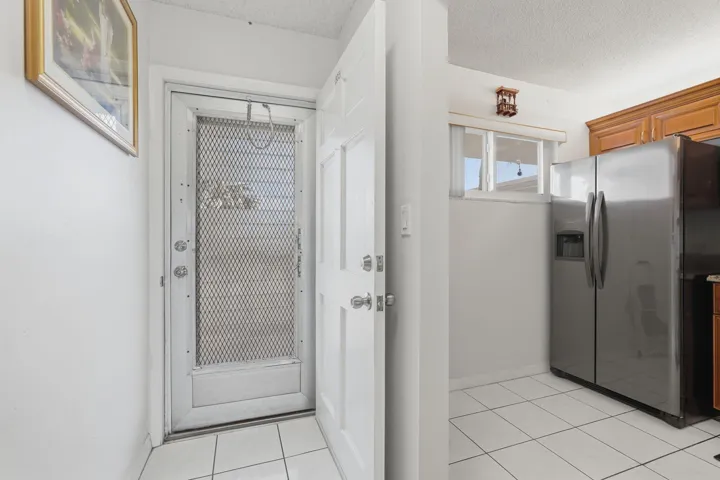View from entry foyer to front door and kitchen