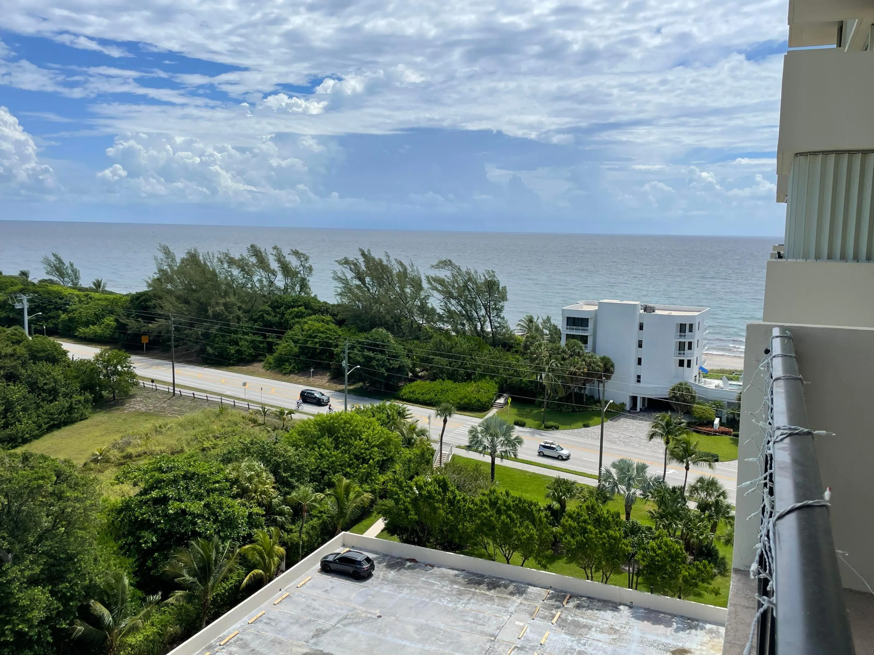 Coastal setting with ocean, road frontage, and lush landscaping