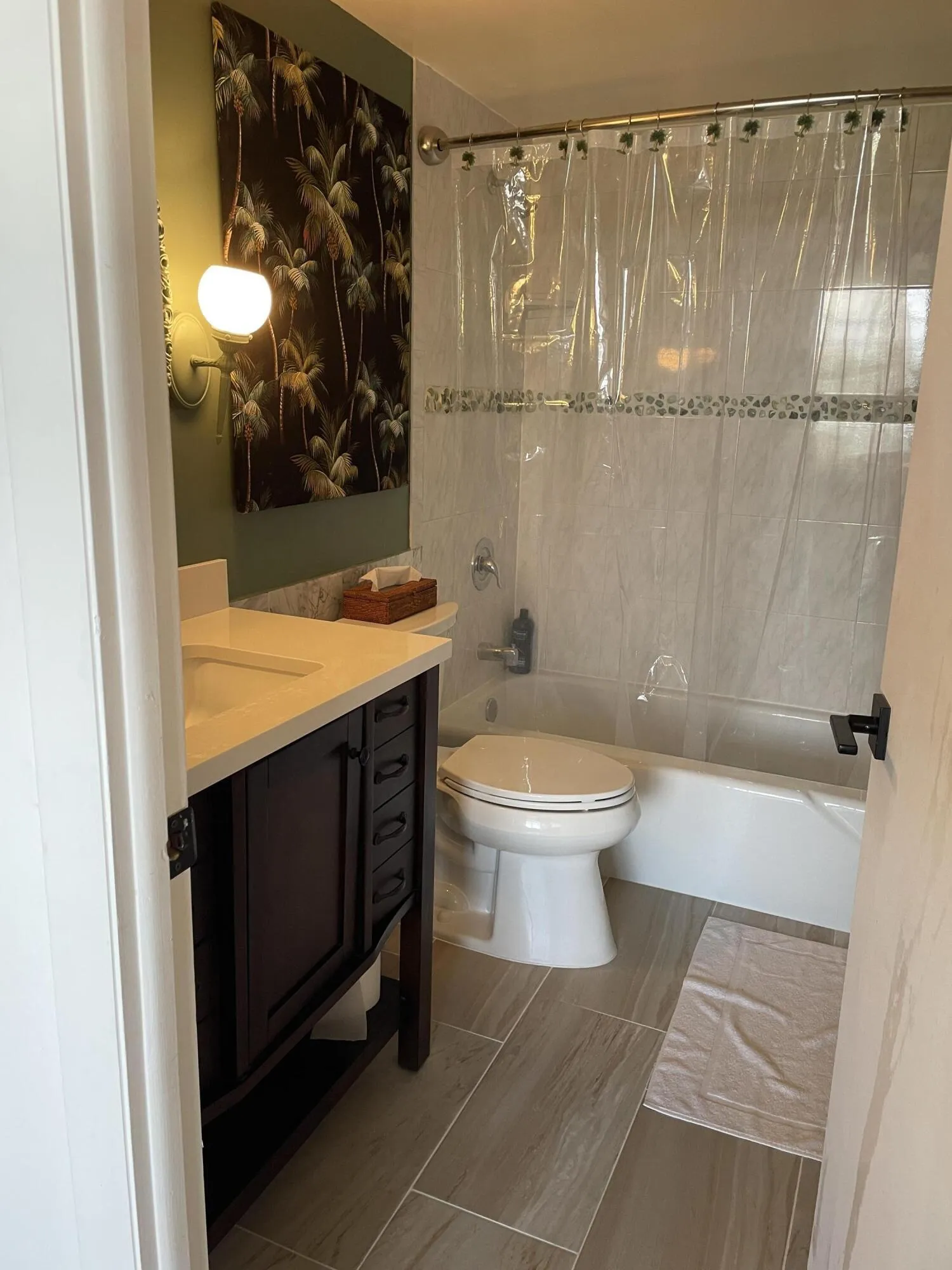 White tiled shower with a decorative accent​​‌​​​​‌​​‌‌​‌‌​​​‌‌​‌​‌​‌​​​‌​​ band