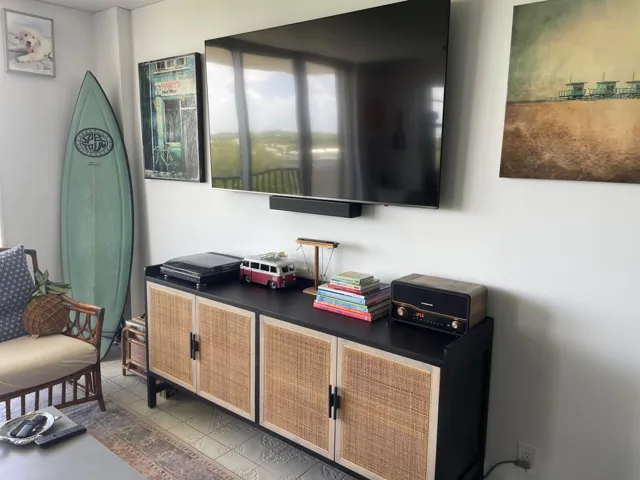 Wall-mounted media console with natural cane door panels