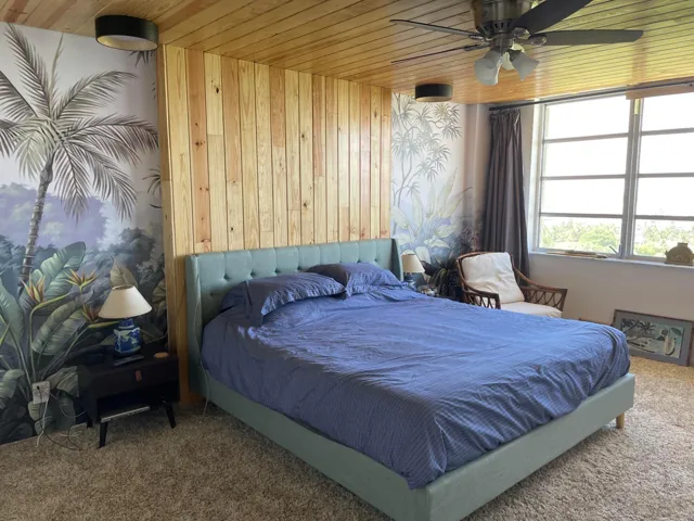 Wood-paneled ceiling with a ceiling fan